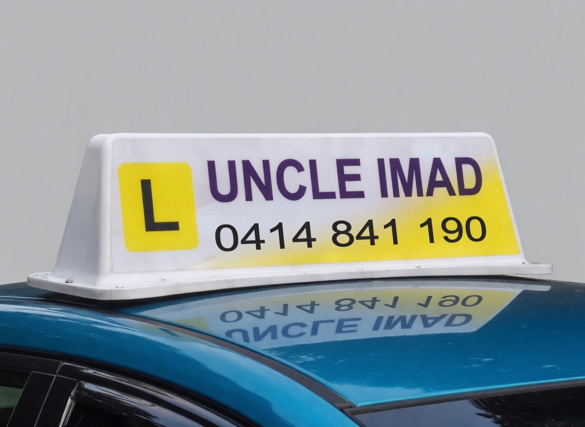 Uncle Imad Driving School car sign, phone 0414 841 190